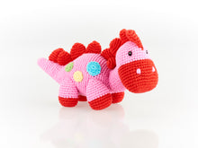 Load image into Gallery viewer, Crochet Stegosaurus Dinosaur. A pink body with  green, yellow  &amp; blue spots, Red feet,  nose and red spikes across its head back and tail. 