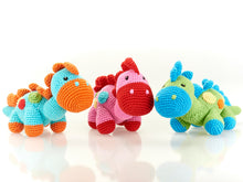 Load image into Gallery viewer, 3 Crochet Stegosaurus Dinosaurs. Available with pink, green or turquoise body with  green, yellow  &amp; blue spots, contrasting feet,  nose and spikes running along its head back and tail. 